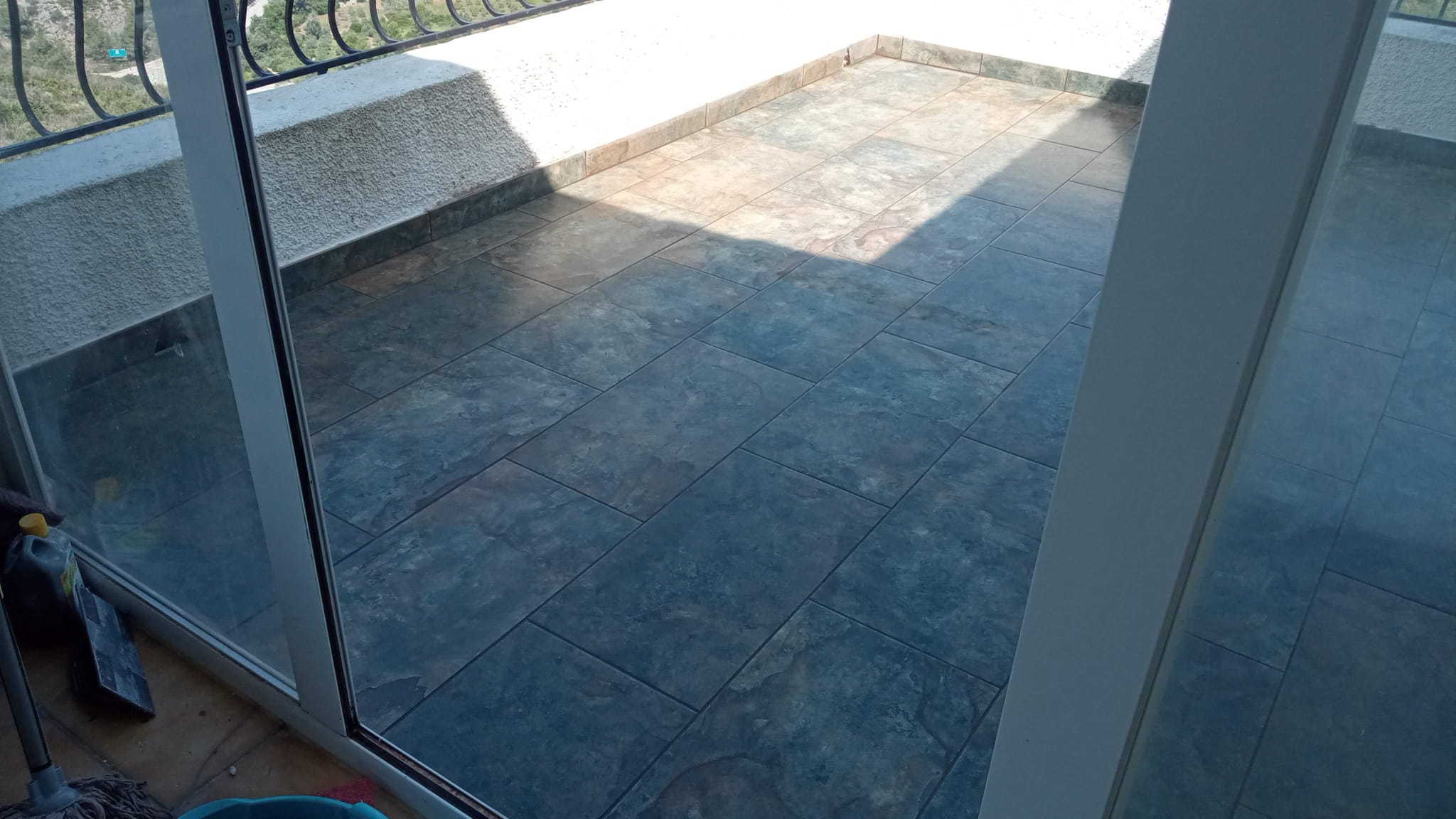 Terrace tiling through glass door